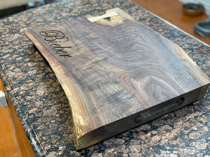 Custom handmade live edge walnut cutting board.